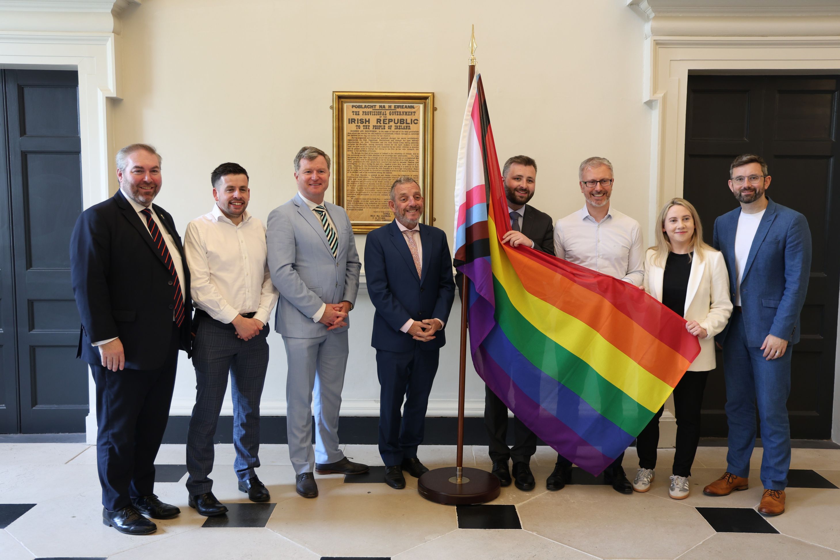 Members of the Irish Parliamentary Rainbow Caucus pictured in Leinster House lobby with a Pride flag